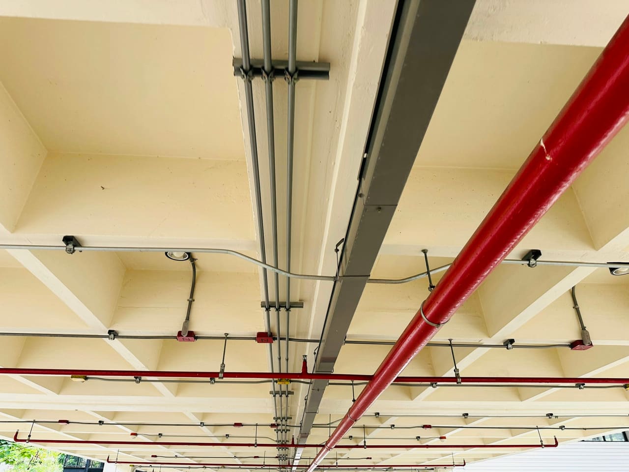 Electrical conduit runs installed across a building ceiling